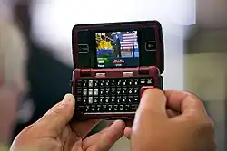 A person in the audience at Monaco RV manufacturing in Wakarusa, Ind. uses their cell phone to record President Barack Obama's remarks on the economy, August 5, 2009.