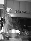 Food preparation demonstration in an early 19th-century kitchen