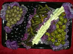 Olives and pickles attractively served on purple cabbage leaves