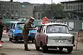 East German officer monitors traffic returning to East Berlin, November 1989.