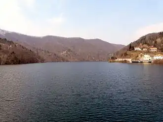A body of water with mountains in the distance.