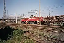 Two diesel locomotives (class Dv12) transporting wood at the Oulu train station freight yard.
