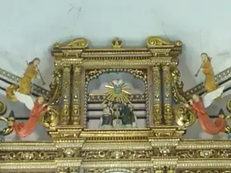 Holy Trinity detail on the polychromed retablo