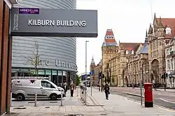 Looking South down the Oxford Road past University place and the Kilburn building sign