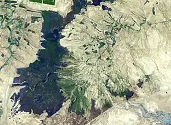 The town of Shadegan, Iran is northeast of where the Tigris and Euphrates Rivers enter the Persian Gulf. It sits near a wetland and upon land that was once part of an inland river delta. The long, linear orchards follow the topography created by the delta. The image was acquired September 3, 2012