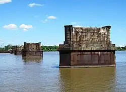 Several masonry bridge piers in a wide river