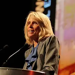 Hartigan at podium speaking at plenary session