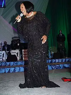 A woman in a black dress singing