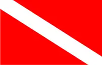 A drawing of a red flag with a white diagonal band from the top of the hoist to the bottom of the fly