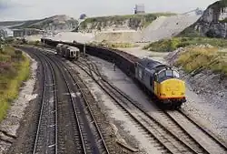 A Class 37 freight train on the line at the limestone sidings, Peak Dale