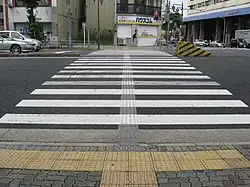 Low-profile directional tactile markings are installed on busy pedestrian crossings in Japan.