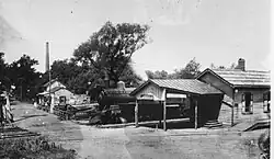 The no longer extant Pennsylvania Railroad depot in Rocky Hill, with the Delaware and Raritan Canal and the smokestack of the Power Station in the background