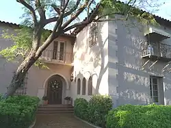 The focal point of the Bennitt Mansion is its arched doorway. The arch is articulated by the use of natural finish concrete formed to replicate cut stone jamb blocks and voussoirs with raked joints. Special craftsmanship is found in the milled door casing, which follows the curve of the semicircular arched opening. The heavy, stained wood door has 11 recessed panel delineated by high-relief moldings. The mansion was listed in the National Register of Historic Places on August 12, 2009, reference #09000609.