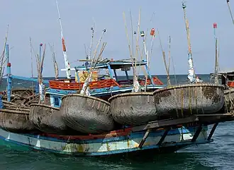 Fishing boat with its collection of basket boats (thuyền thúng)