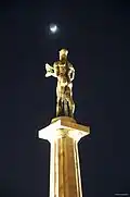 Statue of the Victor at night with the Moon and Ursa Minor seen in the background.
