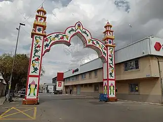 Entrance to a fair, with a sign that reads the name of the town, Armilla