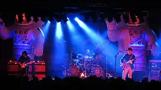 Primus performing in Chicago in 2014. Left to right: Larry "Ler" LaLonde, Danny Carey (Tool), and Les Claypool