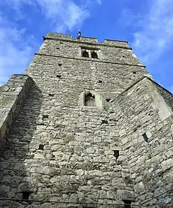 Large grey stone tower, seen from below
