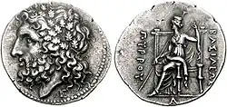 Pyrrhos, King of Epeiros, 297–272 BC. Head of Zeus in wreath of oak / Demeter seated, holding long sceptre and her veil; caption ΒΑΣΙΛΕΩΣ ΠΥΡΡΟΥ (of king Pyrrhus).