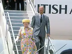 Elizabeth and Philip disembark from a British Airways Concorde supersonic transport aircraft