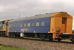 Crew car RZDY 106 (former Bluebird railcar 106 ‘Bittern’) on a Pacific National intermodal train at Snowtown, August 2023.