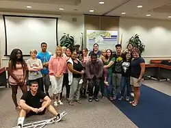 Mitchell standing with a group of people during an appearance for a charity event