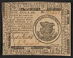 A one-dollar note issued by the Second Continental Congress in 1775 with the inscription: "ONE DOLLAR. THIS Bill entitles the BEARER to receive ONE SPANISH MILLED DOLLAR, or the Value thereof in Gold or Silver, according to a Resolution of CONGRESS, passed at Philadelphia November 29, 1775.."; Within border cuts: "Continental Currency" and "The United Colonies".; Within circle: "DEPRESSA RESURGIT".; Verso: "ONE DOLLAR. PHILADELPHIA: Printed by HALL and SELLERS. 1775."