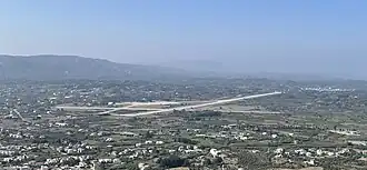 This is a aerial view of Rhodes Air Base used by the Hellenic Air Force. In 1977 civilian traffic stopped and moved to the newer Rhodes Diagoras Airport. Image taken from Filerimos Cross.