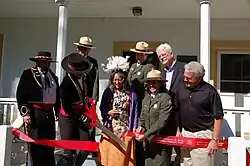 A photo of Yamane surrounded by people at a ribbon cutting ceremony
