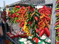 Ristras of jalapeños, other chili peppers, and garlic at a market in Montreal