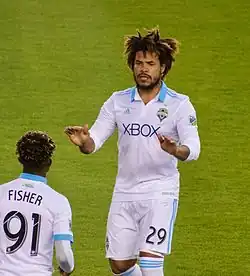 A man wearing a white shirt and shorts.