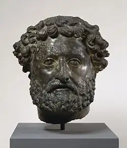 Private portrait with both individualized and unforgiving naturalism and stylized influence of portraits of the emperors Hadrian and Antoninus Pius in his beard and hairstyle.