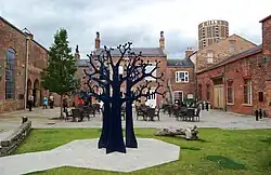 Foundry Square, No. 99 (right) with double doors.[9] Dry Sand foundry (left).