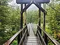 Swing bridge over the Sugar Loaf Stream, a tributary of the Route Burn
