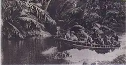 Royal Marines Commando unit armed with machine gun and Sten gun patrolling using a boat in the river on Serudong, Sabah to guard the state during the Indonesia–Malaysia confrontation.