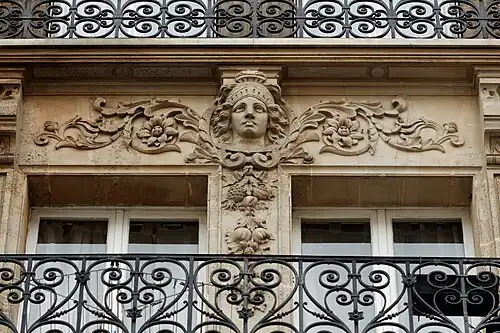 Neoclassical rinceaux with a mascaron of Rue des Vinaigriers no. 57, Paris, designed by E. Escudie, 1882