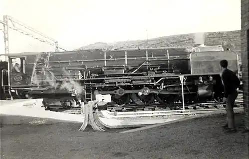 NBL-built no. 3411 relieving electric units on a northbound Trans-Karoo at Beaufort West, Cape Province, 26 June 1966
