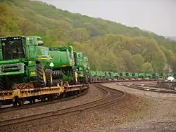 John Deere Combine harvesters being transported by railway in Tyrone, Pennsylvania.