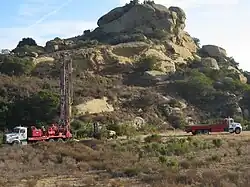 Drilling and flatbed trucks and an all-terrain vehicle