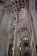 Details in the pillars of mosque, including red and white ablaq in the arches and muqarnas on the pillars and on the pendentives