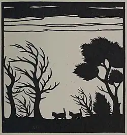 Silhouette of two cats walking across a landscape of trees