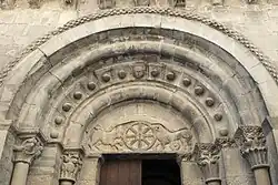 Tympanum of the west portal, showing chrismon and lions