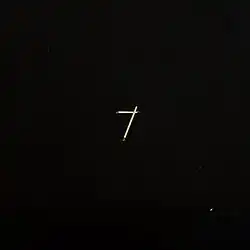 A black cover with two matchsticks making a "7" on it