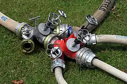 Two 3-way splitters with Storz connectors.