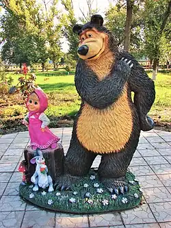 A sculpture of Masha and The Bear along with their friend Hare in Yelan
