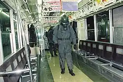 GSDF personnel spraying decontaminant inside contaminated vehicles.