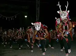 Men with deer masks.
