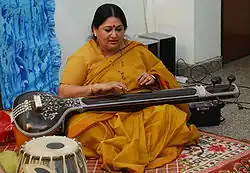 The tambura or tanpura may have a toomba (although not in this picture), a resonator made of calabash at the end of the strings table.[48]