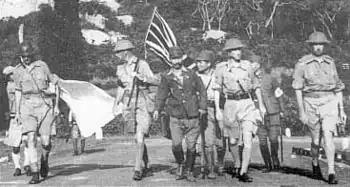 Image 40Lieutenant-General Arthur Percival, led by a Japanese officer, marches under a flag of truce to negotiate the capitulation of Allied forces in Singapore, on 15 February 1942. It was the largest surrender of British-led forces in history. (from History of Singapore)