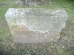 Stone outside Community Center, inscription reads "Gene Deardoff May 21, 1938"